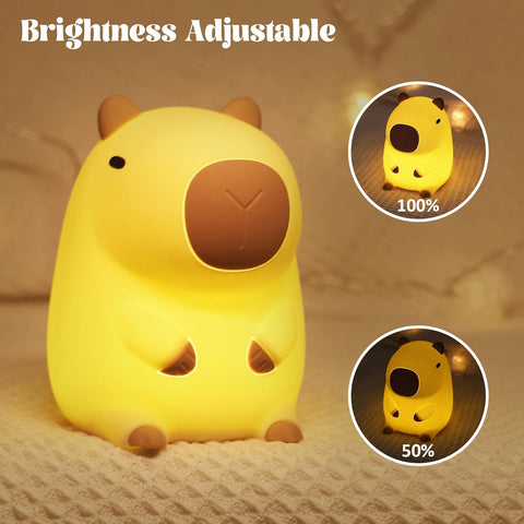 Yellow animal-shaped night light with brightness adjustment indicators on a soft surface.