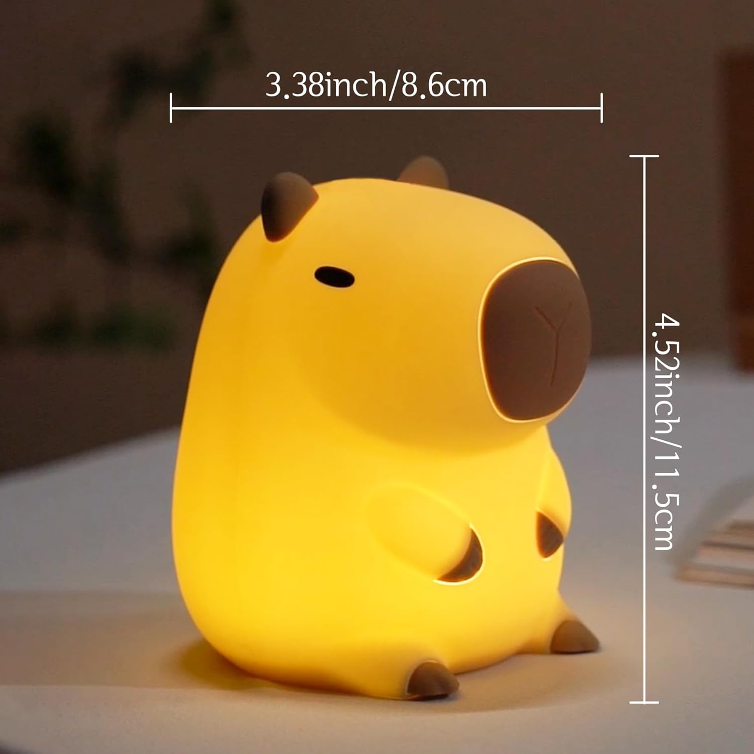 Yellow animal-shaped night light with measurements on a blurred background