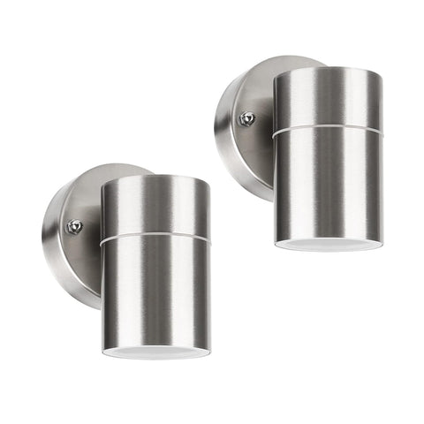 Stainless steel outdoor light casting a warm glow on a garden path

