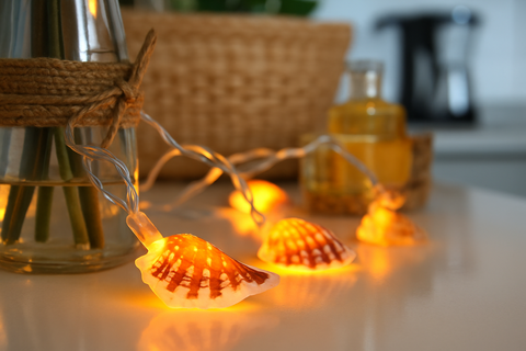 Shell-shaped string lights on a surface with a blurred background