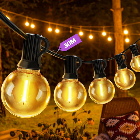 mains-powered G40 festoon lights illuminating garden pergola with warm white glow
