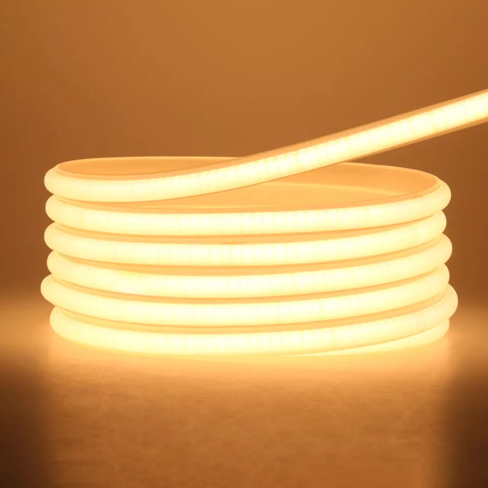Waterproof LED RGB rope light glowing in a UK garden setup.

