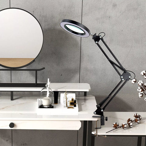 Desk setup with magnifier lamp in clamp mount

