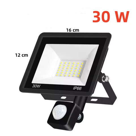 30W LED PIR Floodlight by Alpha Lights with motion sensor activated, lighting up the surroundings

