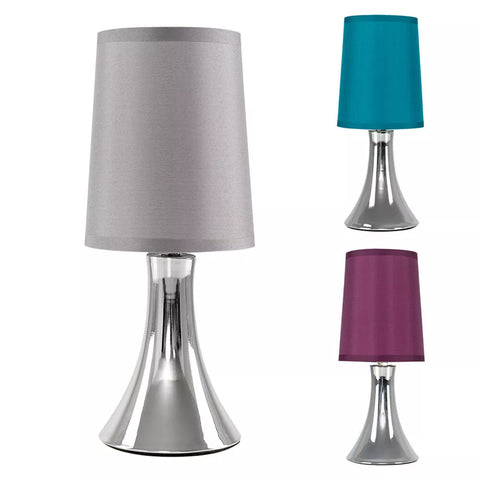 Chrome Touch Table Lamp with fabric shade on a bedside table.​


