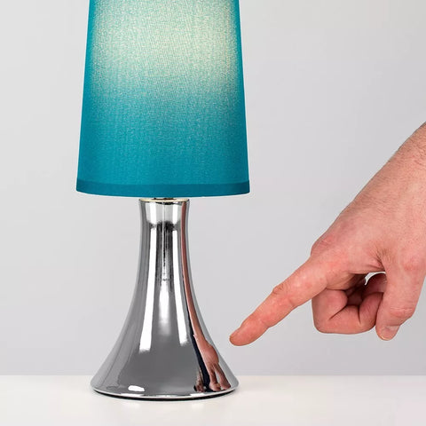 Close-up of the lamp's polished chrome base.​

