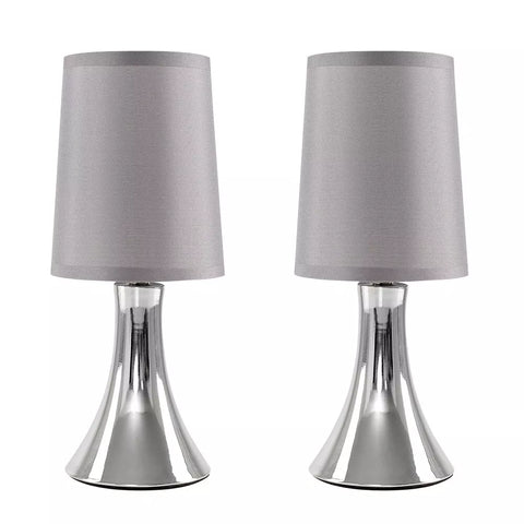 Lamp emitting warm light in a minimalist living room.​

