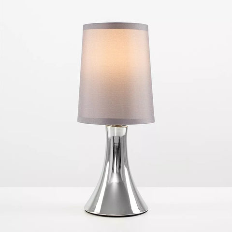 Lamp placed on a modern office desk.​


