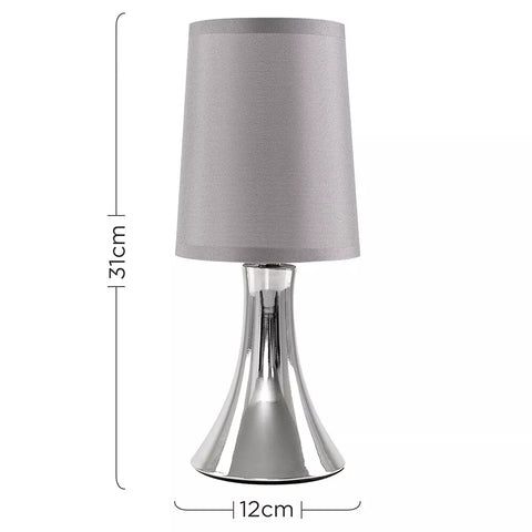 Lamp illuminating a cozy bedroom setting.​

