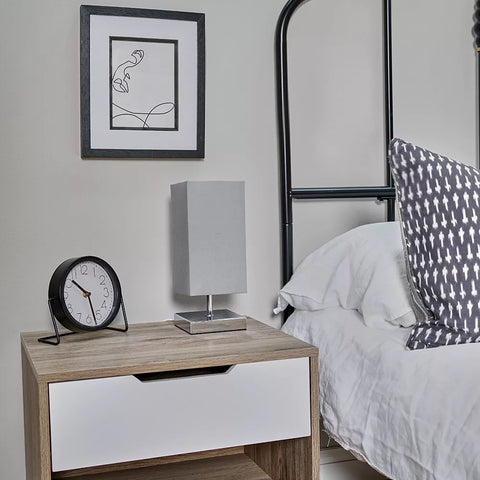 Lamp emitting soft light in a minimalist living room.​

