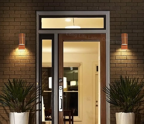 Outdoor wall light casting light on a garden feature at night

