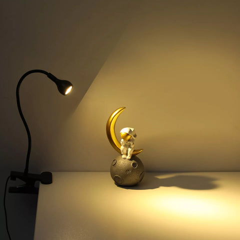Lamp's clip base gripping a thick tabletop

