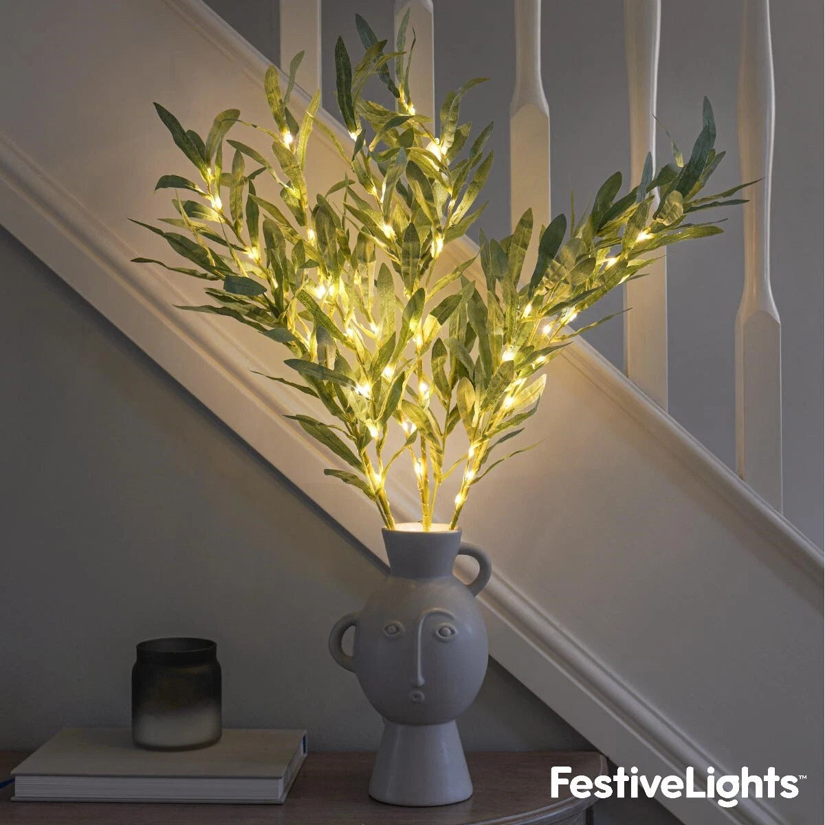 Decorative plant with lights in a vase on a staircase landing