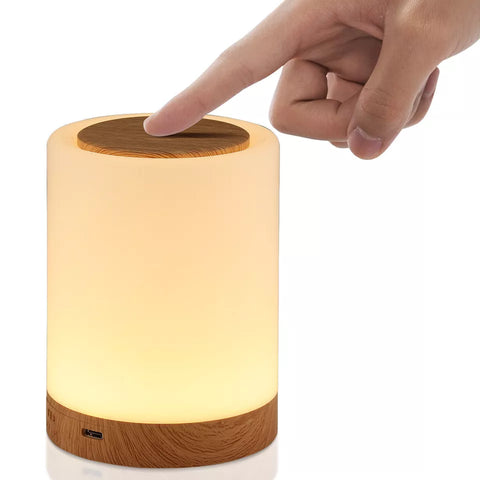 Lamp on a nightstand next to a bed

