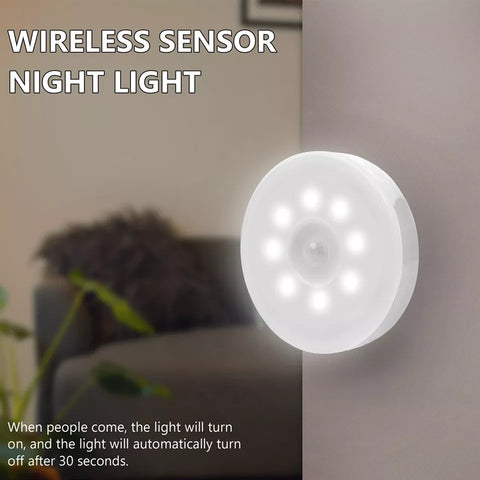 Round rechargeable LED wall light illuminating hallway.

