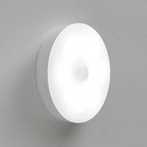 Stick-on motion sensor night light installed on stair wall in UK home.

