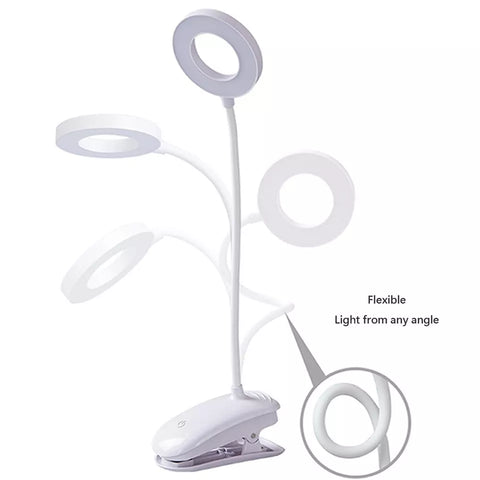 Book lit by warm LED light on a bedside table.


