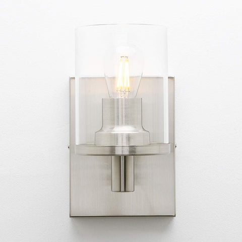 Modern wall sconce with glass shade on a white background