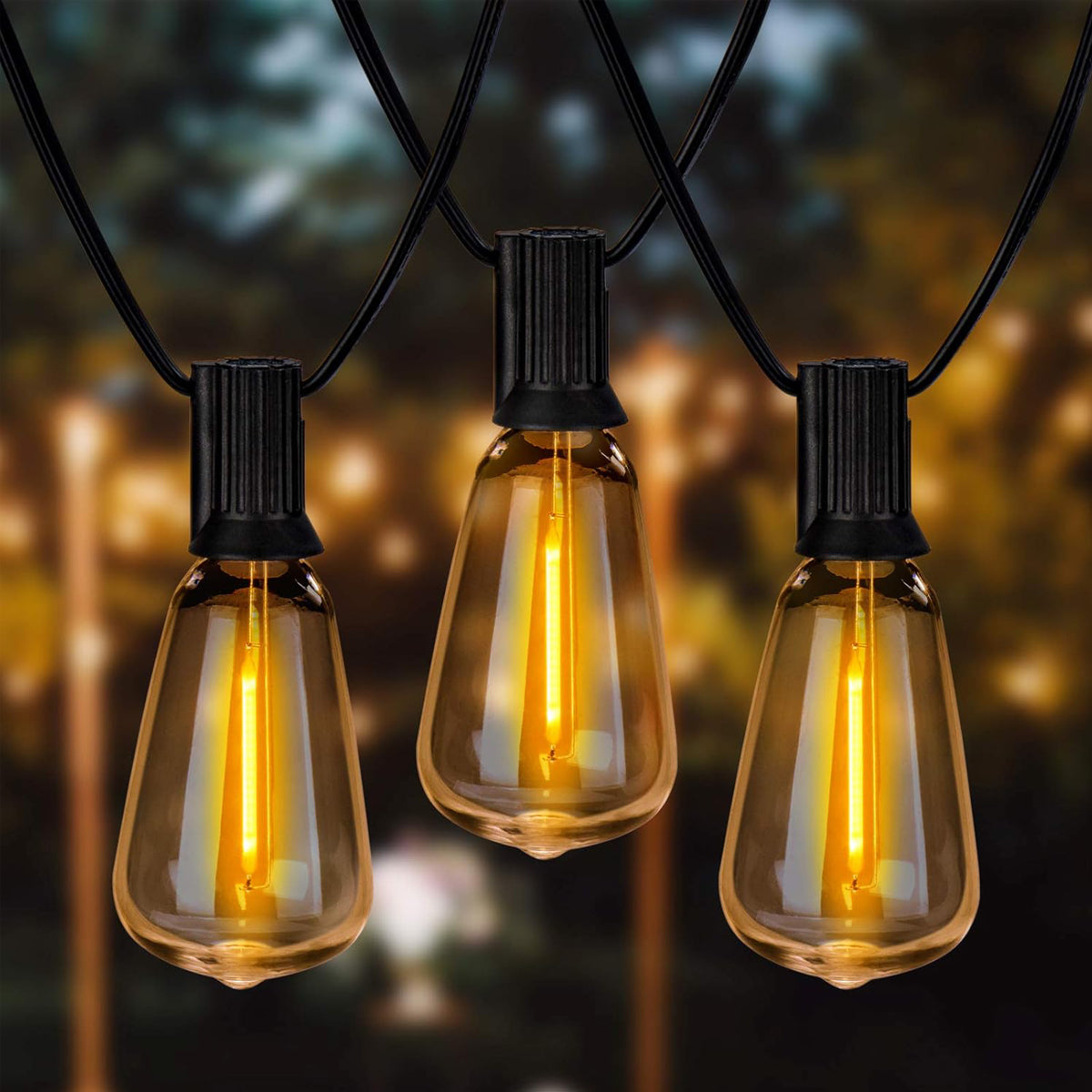 String of illuminated light bulbs against a blurred outdoor background