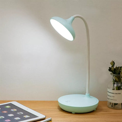 Lamp's compact base on a bedside table.


