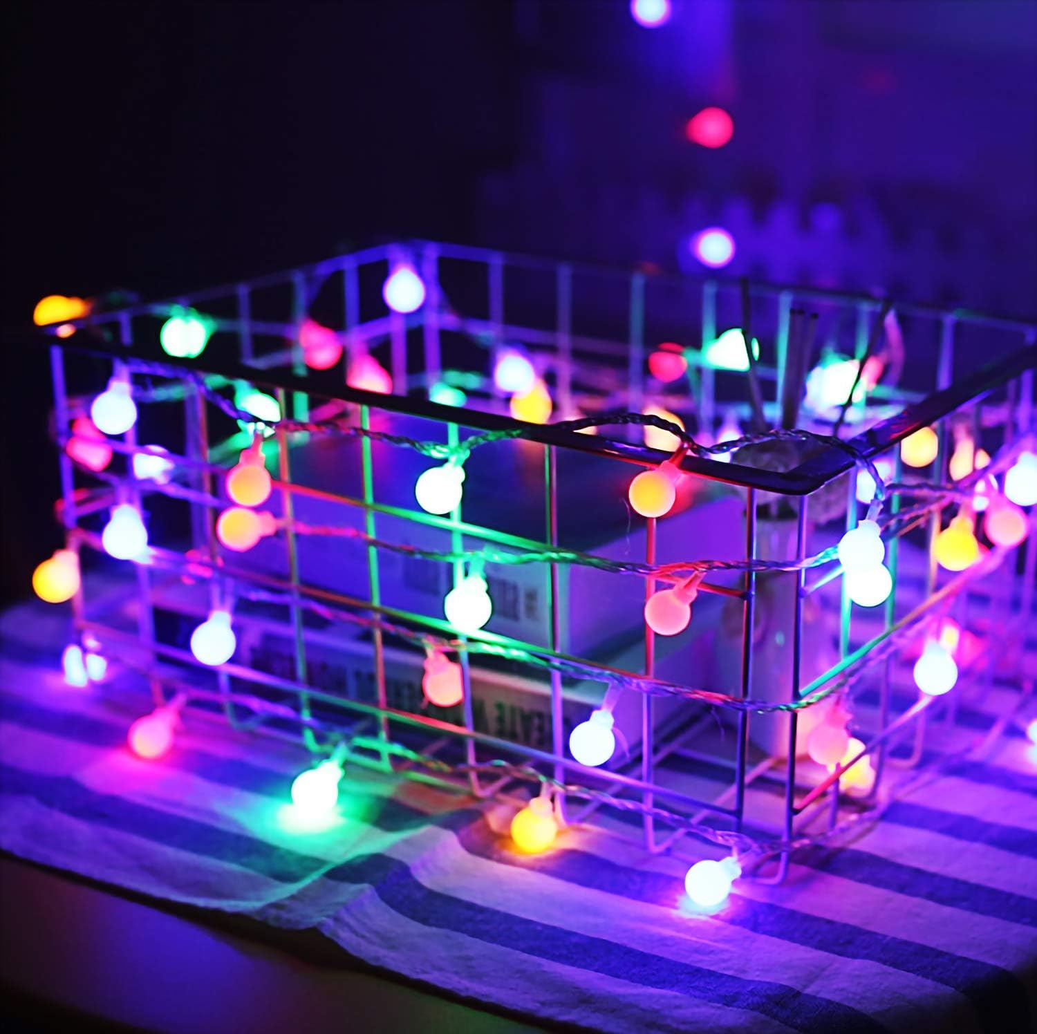 Multicolour LED string lights arranged on a wall

